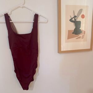 Never worn Fabletics maroon bodysuit with cross back size medium